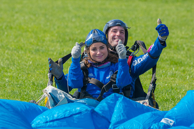 Tandem skydive customer having landed with instructor