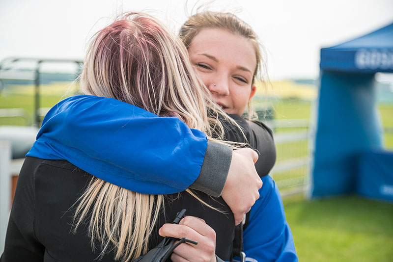 Skydive customer hugging a spectator