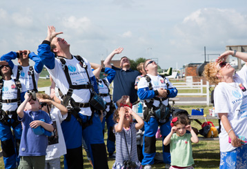 Spectators looking upwards on airfield