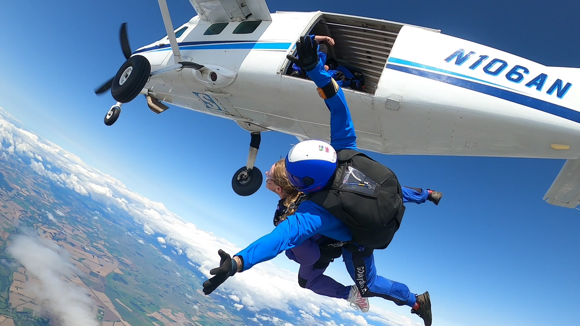 Tandem skydivers exiting the plane